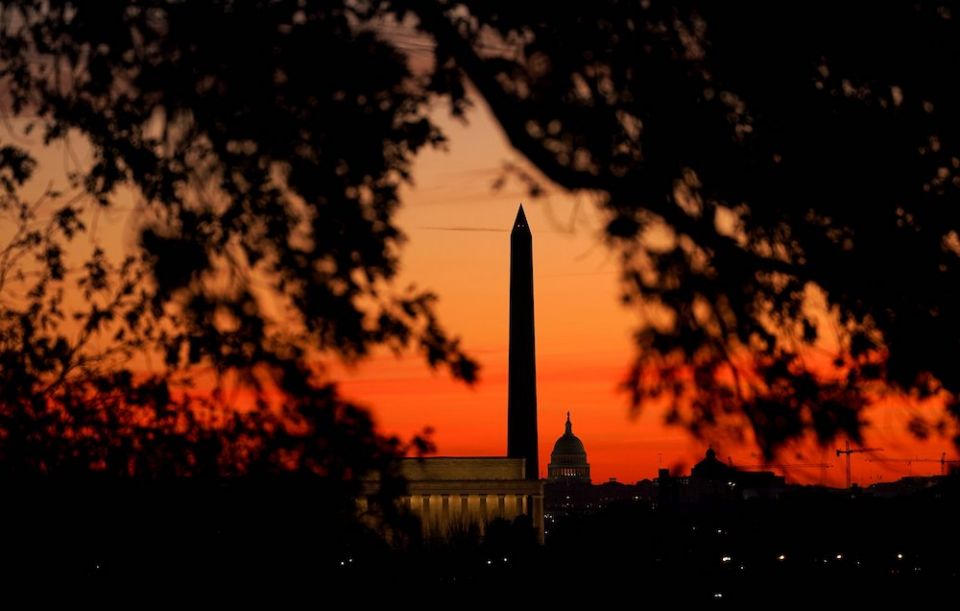The sun rises behind the U.S. Capitol, the Washington Monument and the Lincoln Memorial in Washington Nov. 19. (CNS/Reuters/Kevin Lamarque)