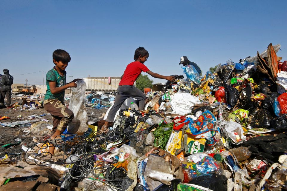 Iraqi children collect recyclable things from a garbage dump in Najaf, Iraq, Oct. 23. (CNS/Alaa Al-Marjani)