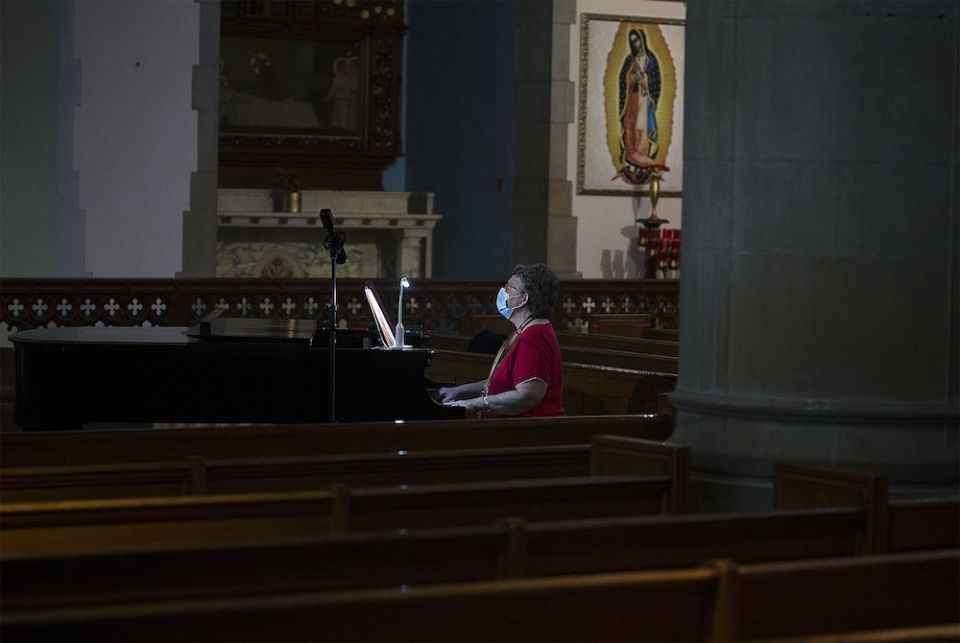 Patricia Burkhardt rehearses prior to Mass at St. Gabriel Catholic Church in Washington July 11. (CNS/Tyler Orsburn)