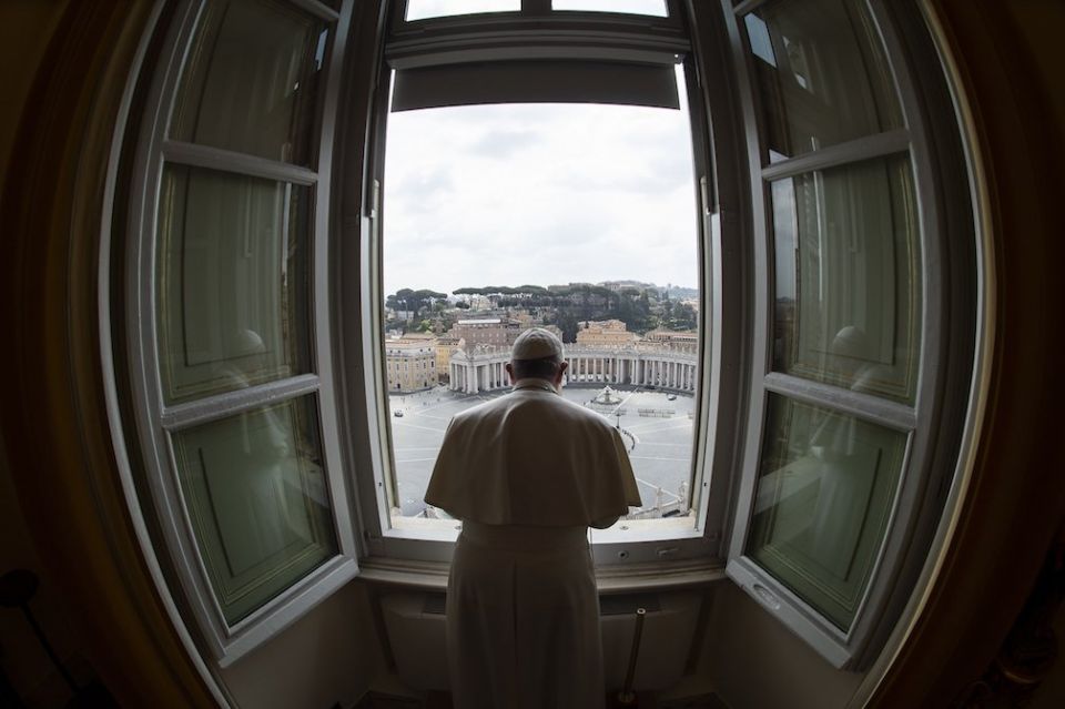 Standing in the window of the library of the Apostolic Palace overlooking an empty St. Peter's Square, March 29, Pope Francis blesses the city of Rome, which was under lockdown to prevent the spread of the coronavirus. (CNS/Vatican Media)