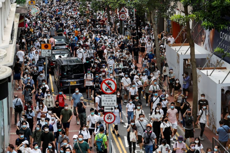Demonstrators march during a protest against the national security law in Hong Kong July 1. (CNS/ Reuters/Tyrone Siu)