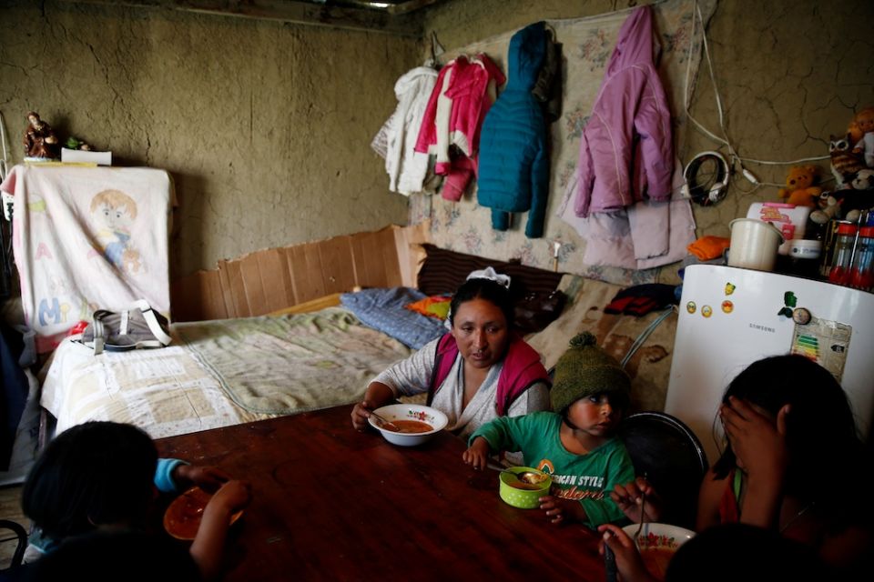 A family eats lunch inside their home during a food and fuel shortage because of a political crisis in La Paz, Bolivia, Nov. 21, 2019. (CNS/Reuters/David Mercado)