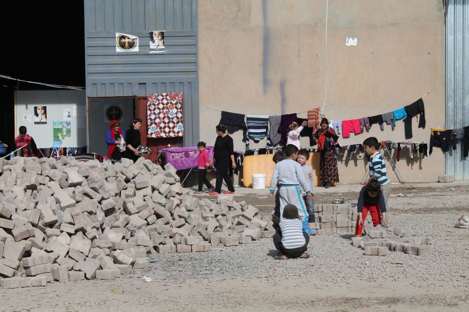 Iraqi Christian children play with concrete blocks Jan. 21, 2015, in a camp, new at the time, set up for the displaced on the outskirts of Ainkawa, Iraq. (CNS/Dale Gavlak) Iraqi Christian children play with concrete blocks Jan. 21, 2015, in a camp, new at the time, set up for the displaced on the outskirts of Ainkawa, Iraq. (CNS/Dale Gavlak)