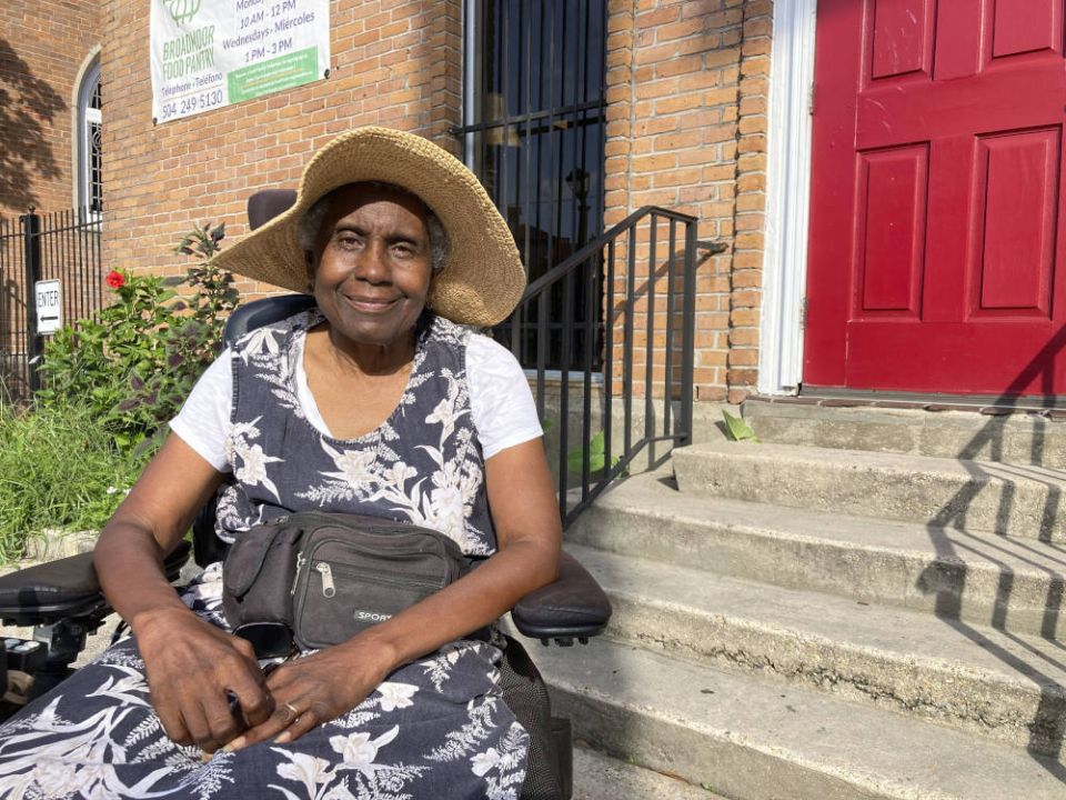 Sonia St. Cyr, a 74-year-old New Orleans resident who uses an electric wheelchair, poses for a photo on July 21, 2022, outside the Broadmoor Community Church where she volunteers at a food pantry. (AP Photo/Rebecca Santana)