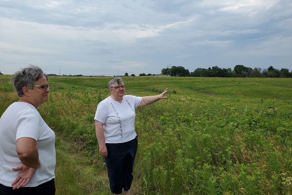 Sr. Marie Cigrand, right, describes the boundaries of her community's conservation easement, as Sr. Cathy Katoski, former president of the Sisters of St. Francis of Dubuque, Iowa, looks on. (EarthBeat photo/Brian Roewe)