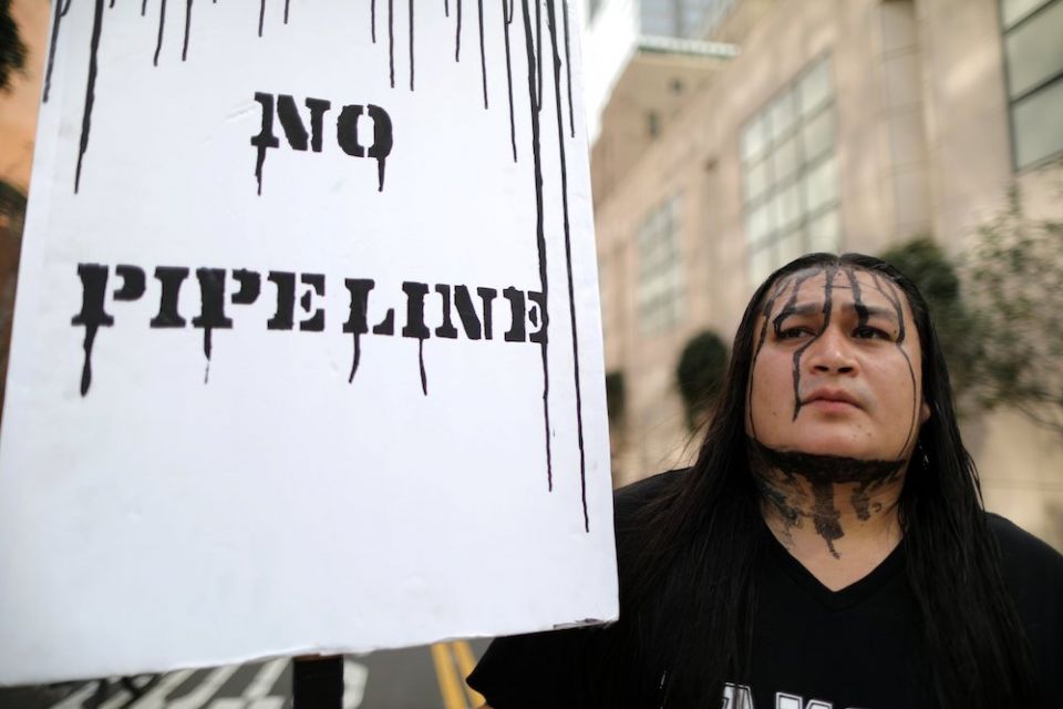 Pipeline projects spark protest not only at rural construction sites, but also among urban activists like this demonstrator in Los Angeles in 2017. (CNS photo/Lucy Nicholson, Reuters)