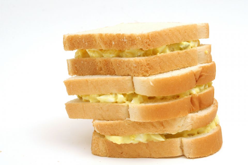 Stack of three egg salad sandwiches on white bread (Dreamstime/Andi Berger)