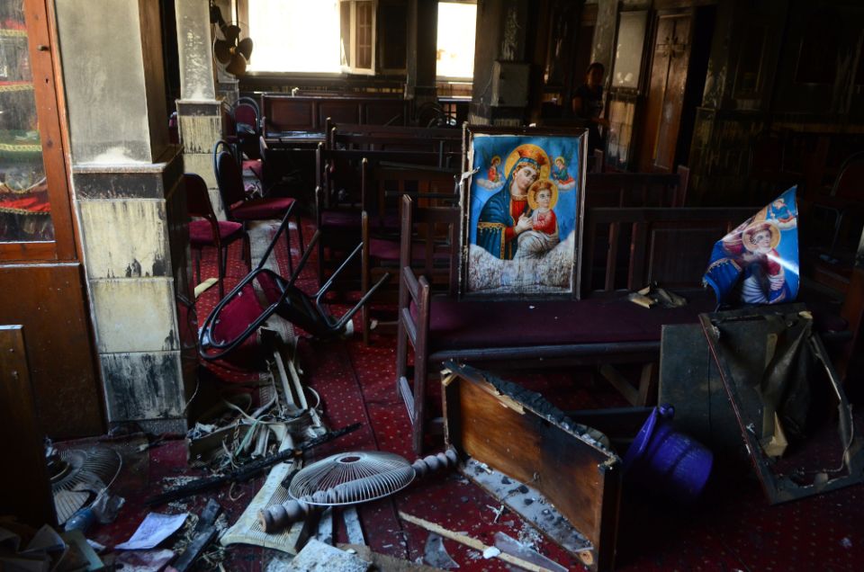Burned furniture, including wooden tables and chairs, and a religious images are seen at the site of a fire inside the Abu Sefein Coptic church that killed at least 40 people and injured some 14 others, Aug. 14 in Imbaba, Cairo Egypt. (AP/Tarek Wajeh)
