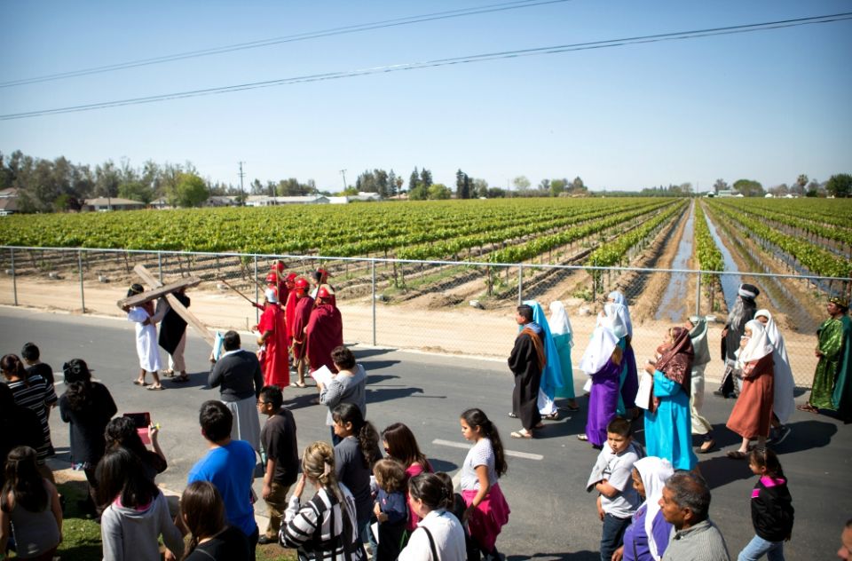 A person carrying a cross leads the Way of the Cross procession on Good Friday in the Diocese of Fresno, California, April 3, 2015. The tradition of a living Stations of the Cross is especially strong in the diocese's migrant communities. (CNS)