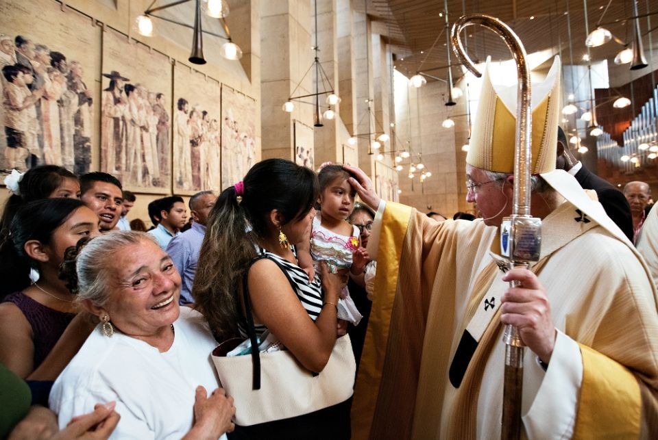 Archbishop José Gomez blesses a girl during a special Mass celebrated in recognition of all immigrants at the Cathedral of Our Lady of the Angels in Los Angeles in July 2016. (CNS/Vida Nueva/Victor Aleman) Archbishop José Gomez blesses a girl during a special Mass celebrated in recognition of all immigrants at the Cathedral of Our Lady of the Angels in Los Angeles in July 2016. (CNS/Vida Nueva/Victor Aleman)
