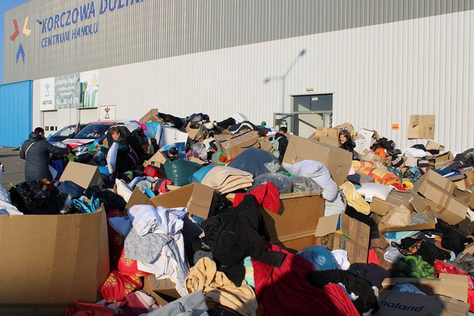 Donated clothing piles up Sunday, March 13, at a refugee center reception center near Korczowa, in southeastern Poland. (NCR photo/Chris Herlinger)