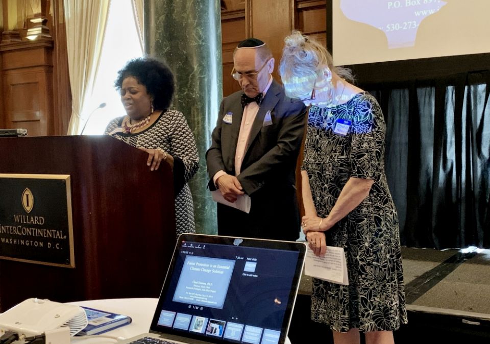 The Rev. Lisa Gray prays with Rabbi Richard Marker and Connie Hanson during the 20th annual prayer breakfast of the National Religious Coalition on Creation Care May 6 in Washington, D.C. (National Religious Coalition for Creation Care)