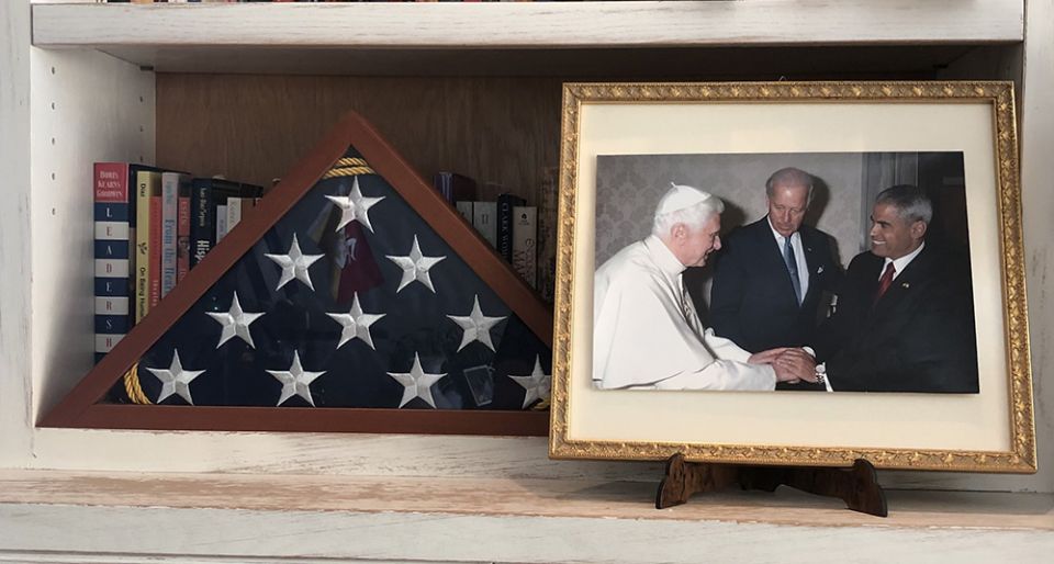 In a photo on his bookshelf, Miguel Díaz, right, greets Pope Benedict XVI during the meeting at the Vatican with then-U.S. Vice President Joe Biden in June 2011. (Provided photo)