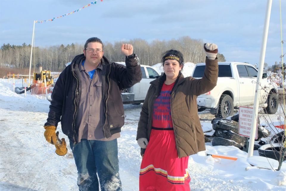 Jason Goward and Taysha Martineau in front of an Enbridge Line 3 worksite on the Fond du Lac reservation. (Photo by Mary Annette Pember, Indian Country Today)