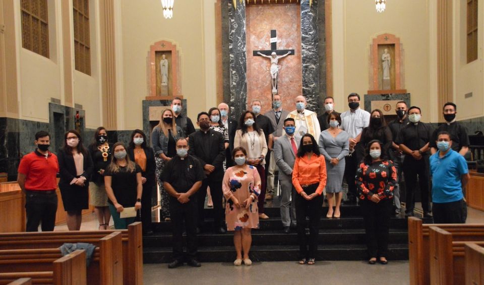 The Diocese of Joliet's 24 chosen Latino Pastoral Leaders Initiative participants were blessed by Bishop Richard Pates in the Cathedral of St. Raymund Nonnatus on Sept. 15. Accompanying these leaders are Director of Evangelization Andrew Isbell, in gray, 