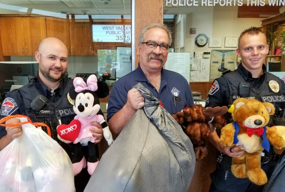 Utah Knights of Columbus 4th Degree District Marshall Richard Vigor, center, is flanked by members of the West Valley City Police Department following the Knights’ collection drive for stuffed animals for traumatized children. (Courtesy of Andy Airriess)