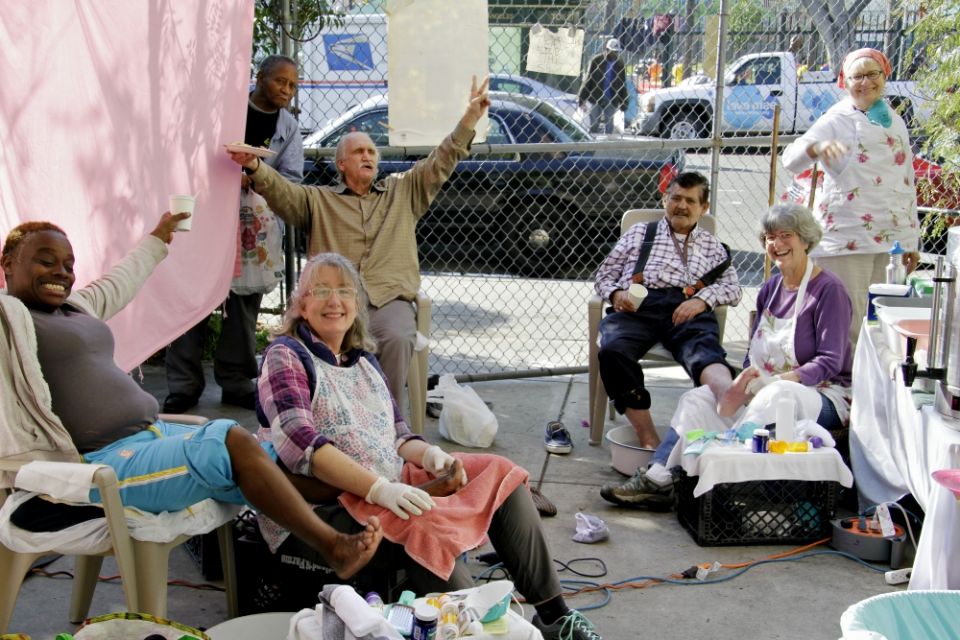 Volunteers provide foot care for patients during one of the Los Angeles Catholic Worker's weekly health outreach days. (Michael Wisniewski)