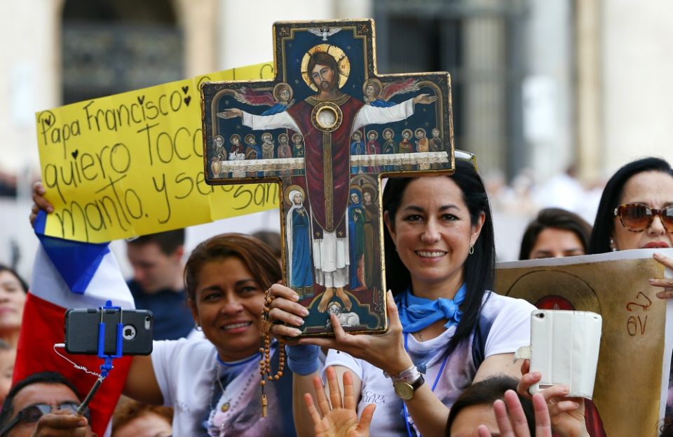 A woman holds an icon of Jesus as Pope Francis leads his general audience in St. Peter's Square at the Vatican Sept. 19, 2018. (CNS/Paul Haring)