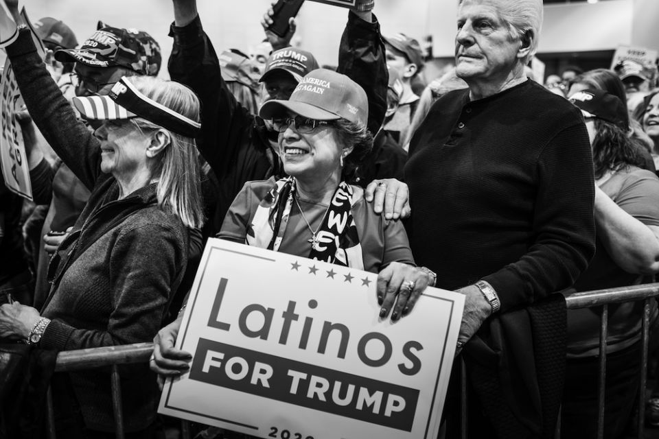 A woman holds a "Latinos for Trump" sign at a Las Vegas "Make America Great Again" rally in February (Courtesy of Bear Guerra and Quiet Pictures)