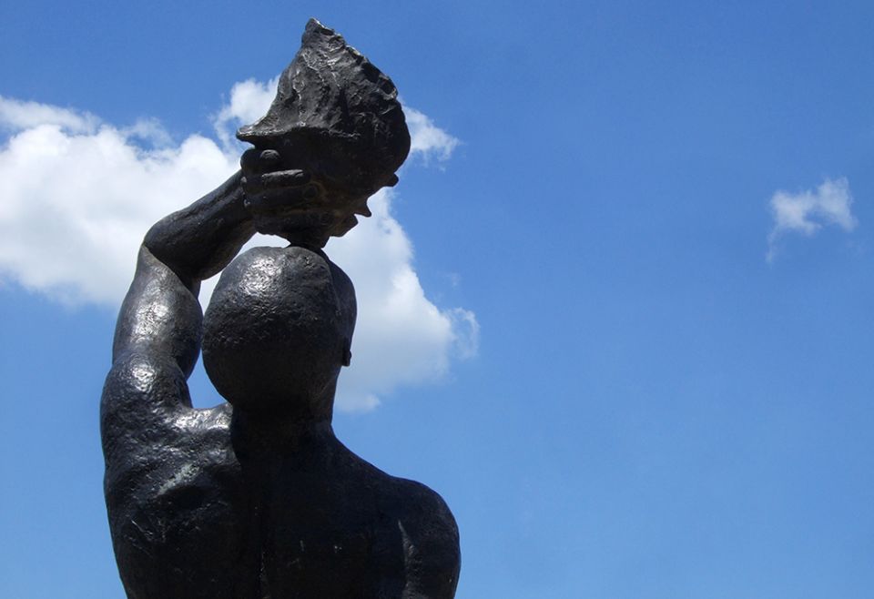 Detail of "Le marron inconnu," a bronze statue of a Black man escaped from slavery and blowing a conch shell trumpet. Created by Haitian architect and sculptor Albert Mangonès, the statue stands across from the National Palace in Port-au-Prince, Haiti.