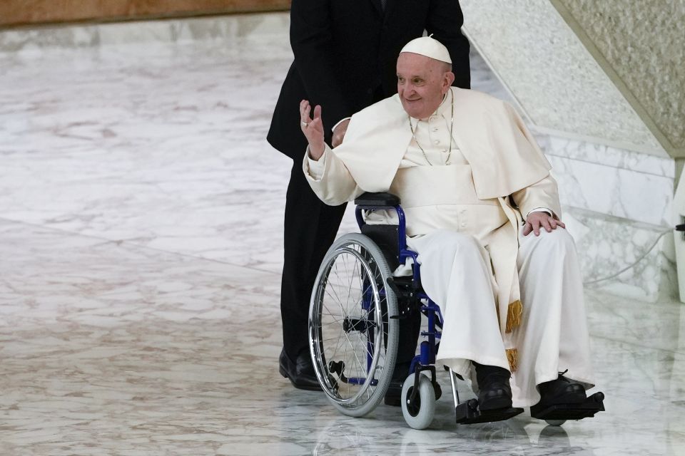 Pope Francis arrives in a wheelchair to attend an audience in the Paul VI Hall at The Vatican, May 5, 2022. (AP Photo/Alessandra Tarantino, File)
