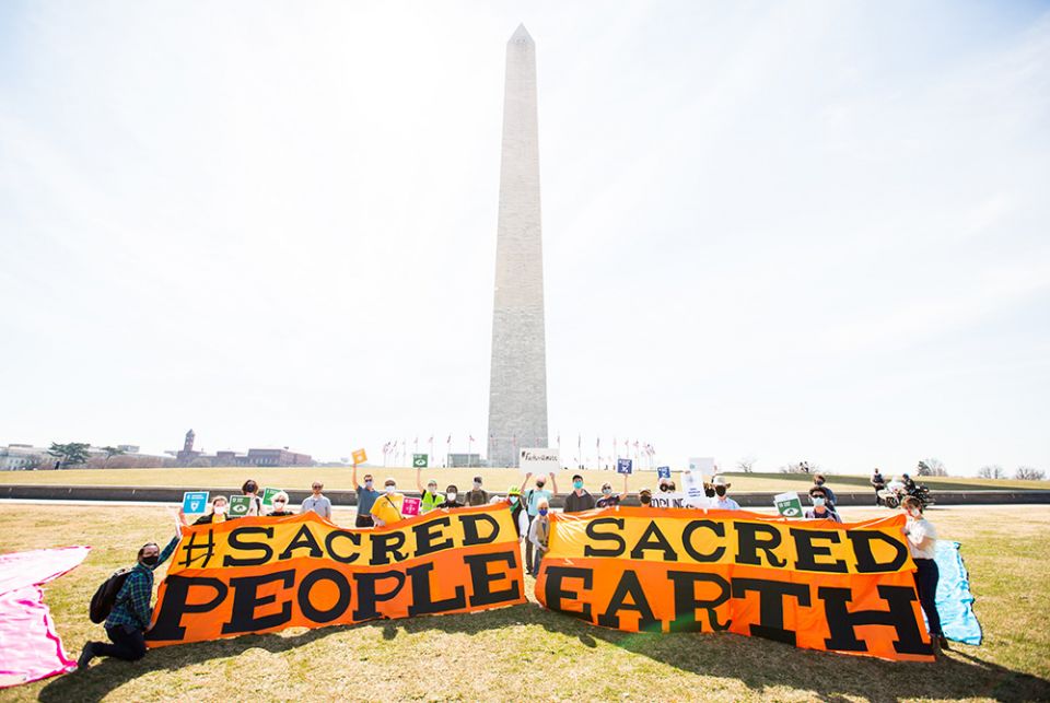 On March 11, people of faith around the world staged hundreds of events, including at the Washington Memorial in Washington, D.C., as part of the "Sacred People, Sacred Earth" day of demonstrations calling on governments and banks to do more to address cl On March 11, people of faith around the world staged hundreds of events, including at the Washington Memorial in Washington, D.C., as part of the "Sacred People, Sacred Earth" day of demonstrations calling on governments and banks to do more to address cl