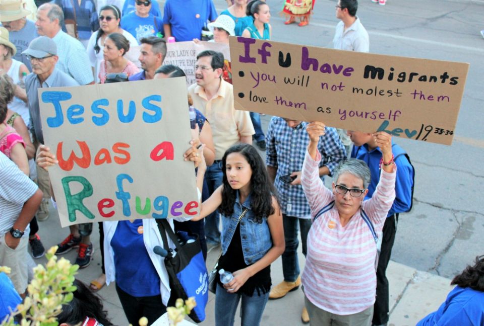 Prior to entering St. Patrick Cathedral July 20 in El Paso, Texas, people raise their banners in quiet prayer and unity. (MVO Photography/Lulu Olvera) Prior to entering St. Patrick Cathedral July 20 in El Paso, Texas, people raise their banners in quiet prayer and unity. (MVO Photography/Lulu Olvera)