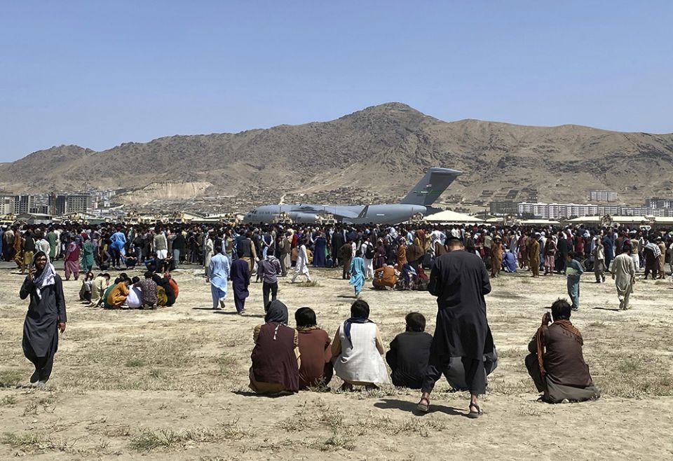 Hundreds of people gather near a U.S. Air Force C-17 transport plane at the perimeter of the international airport Aug. 16, 2021, in Kabul, Afghanistan. (AP photo/Shekib Rahmani, File) Hundreds of people gather near a U.S. Air Force C-17 transport plane at the perimeter of the international airport Aug. 16, 2021, in Kabul, Afghanistan. (AP photo/Shekib Rahmani, File)