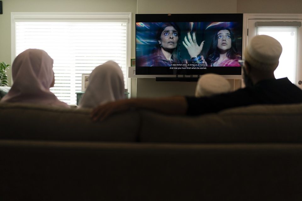 The Zakir family watches an episode of "Ms. Marvel" in Anaheim, California, on July 8. The new series on Disney+ has resonated with Muslims in the West. The show's refreshing approach to portraying the everyday lives of American Muslims has won many heart