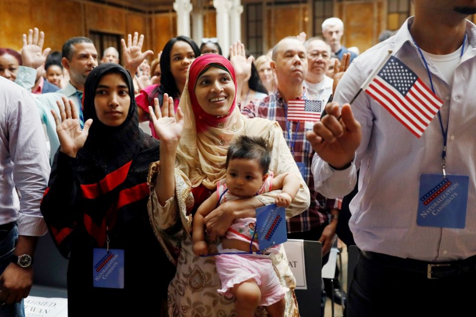 New citizens stand during the Pledge of Allegiance in July 2018 at the U.S. Citizenship and Immigration Services naturalization ceremony in the Manhattan section of New York City. (CNS/Reuters/Shannon Stapleton)
