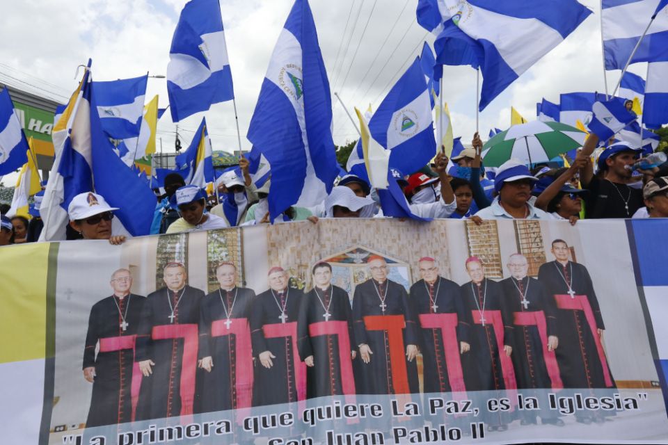 Anti-government demonstrators hold a banner featuring a group of Catholic cardinals during a march supporting the Catholic Church, in Managua, Nicaragua, July 28, 2018. (AP file/Alfredo Zuniga)
