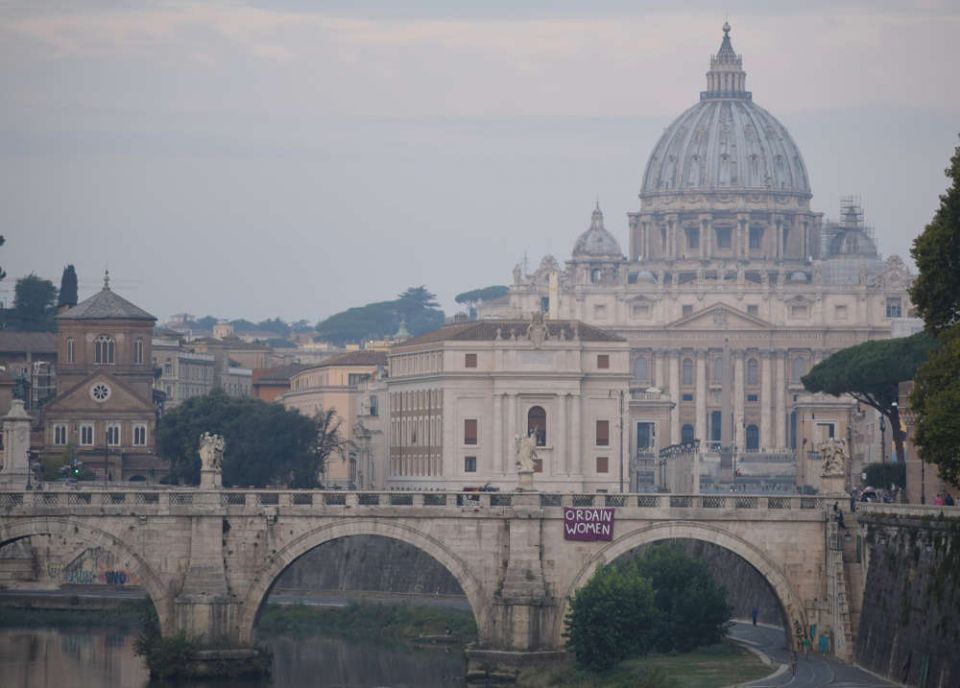 a purple banner reading "Ordain Women" was placed on the Sant'Angelo bridge