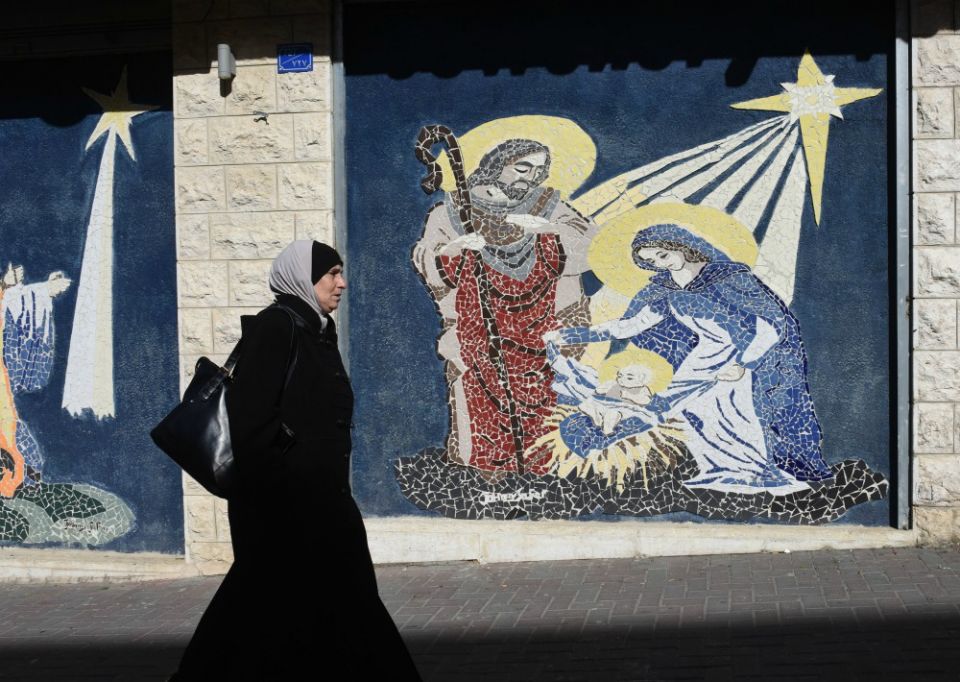 A Palestinian woman walks by a mosaic of the Nativity in Bethlehem, West Bank, Dec. 17, 2018. (CNS/Debbie Hill) A Palestinian woman walks by a mosaic of the Nativity in Bethlehem, West Bank, Dec. 17, 2018. (CNS/Debbie Hill)