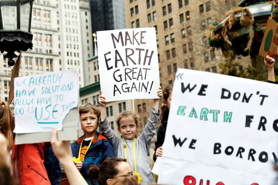 Students hold signs in New York City March 15 to demand action on climate change. Students from around the world participated in the "strike." (CNS/Reuters/Shannon Stapleton)