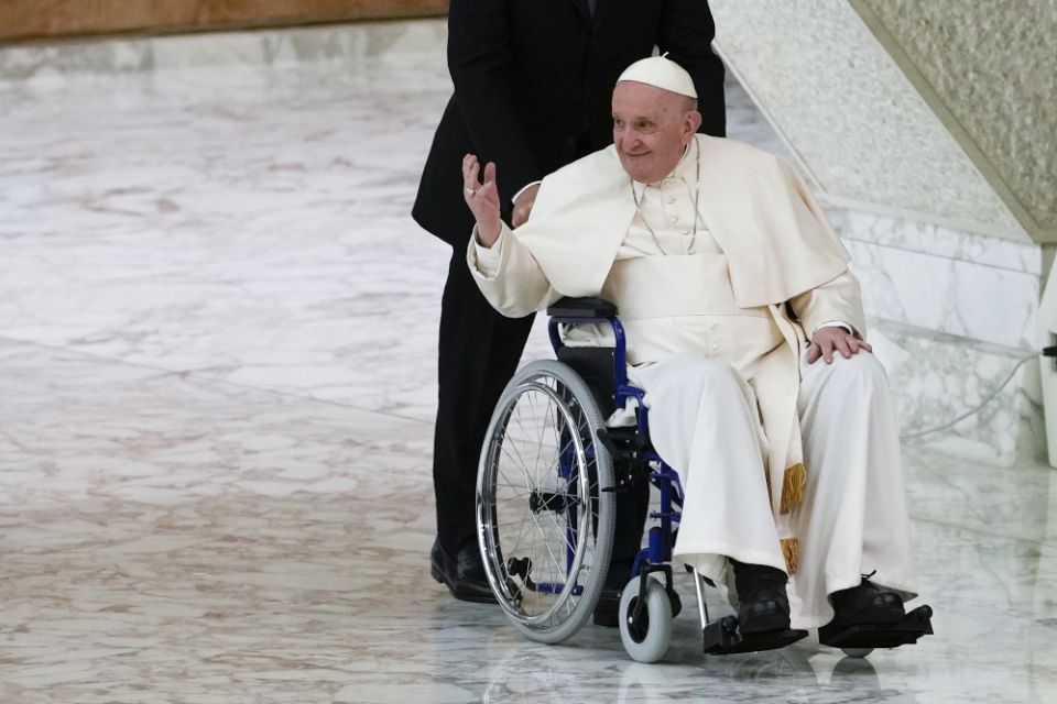 Pope Francis arrives in a wheelchair to attend an audience with nuns and religious superiors in the Paul VI Hall at the Vatican May 5. (AP file/Alessandra Tarantino)