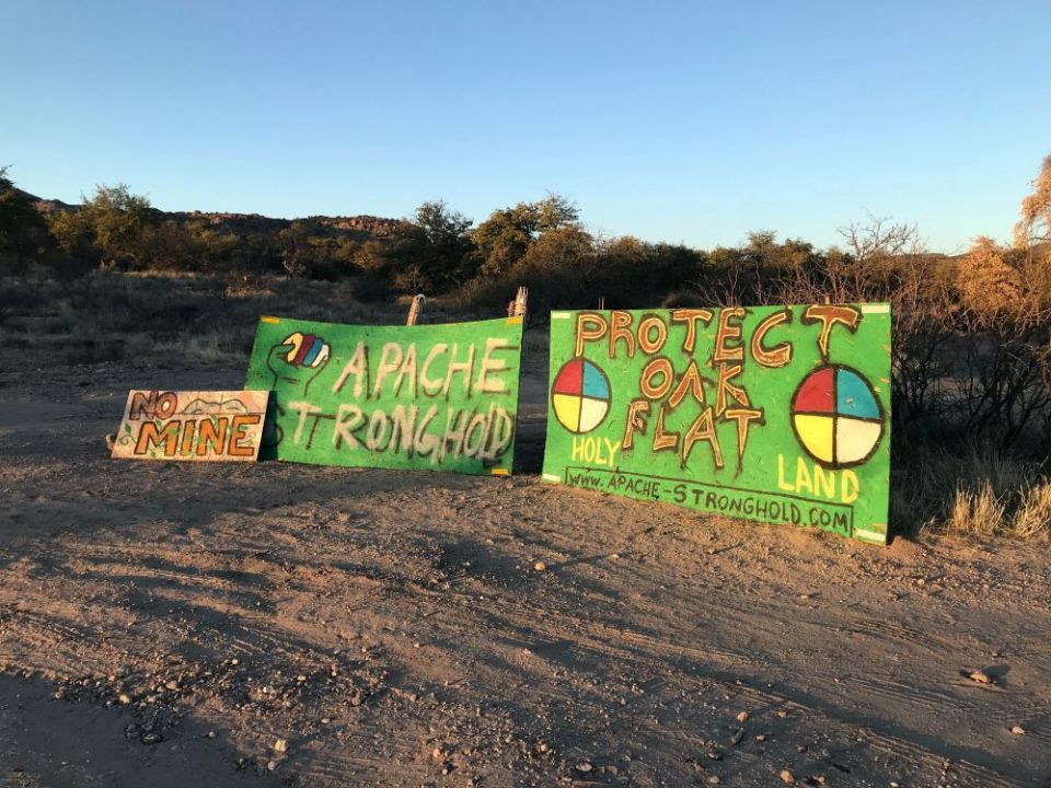 Signs are seen protesting a copper mine at Oak Flat, a site in Arizona considered sacred by the Western Apache and other Native tribes, and advocating to protect the land. (RNS)