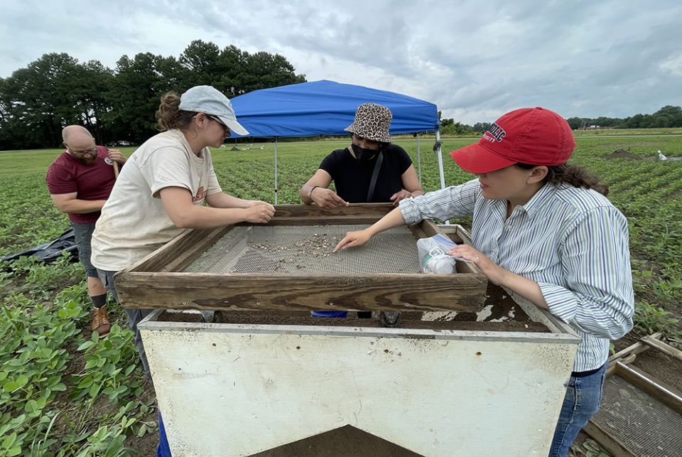 Jesuit Br. Ken Homan; Colleen Betti, field technician and Ph.D. candidate; Robin Proudie, a Missouri descendant; and Laura Masur, professor of the Catholic University of America at the plantation dig site at St. Inigoes in Maryland (Kevin Porter)