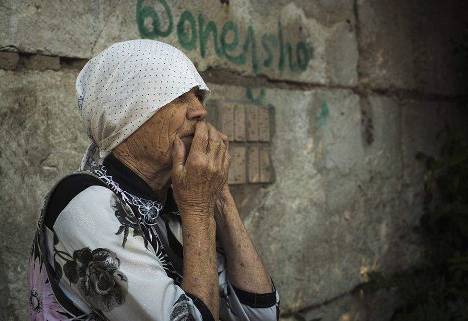 An elderly Ukrainian woman looks on after Russian shelling in Mykolaiv, Ukraine, June 29. (AP/George Ivanchenko)