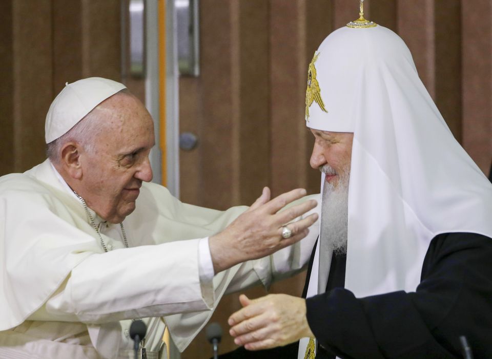 Pope Francis, left, reaches to embrace Russian Orthodox Patriarch Kirill in Havana, Cuba Feb. 12, 2016. (AP Photo/Gregorio Borgia, Pool)
