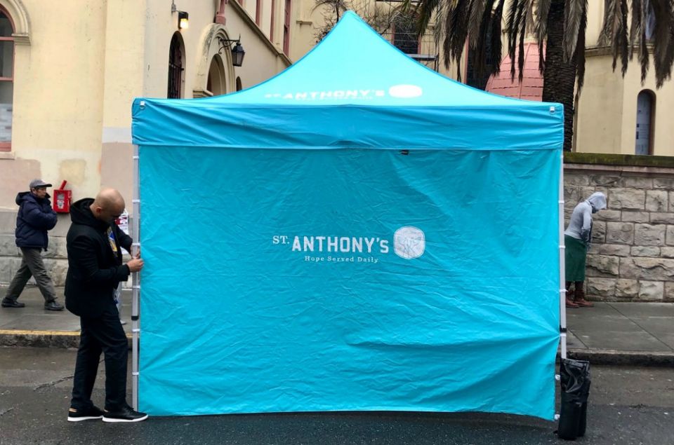 Volunteers set up a tent before distributing meals at St. Anthony's in San Francisco. (Provided photo) Volunteers set up a tent before distributing meals at St. Anthony's in San Francisco. (Provided photo)