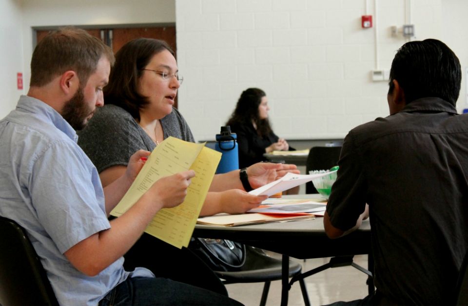 Michelle Sardone, second from left, and another staff volunteer from Catholic Legal Immigration Network assist at a screening for those with Deferred Action for Childhood Arrivals status Sept. 11 at St. John Neumann Catholic Church in Reston, Virginia. Michelle Sardone, second from left, and another staff volunteer from Catholic Legal Immigration Network assist at a screening for those with Deferred Action for Childhood Arrivals status Sept. 11 at St. John Neumann Catholic Church in Reston, Virginia.