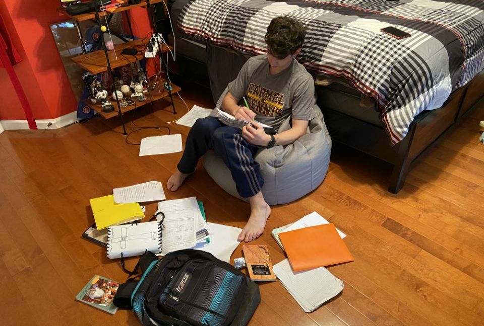 For the time being, Tommy Borkowski's bedroom will double as his classroom, as the Chicago Archdiocese closed all school buildings in efforts to contain the spread of the coronavirus. (Gina Borkowski)