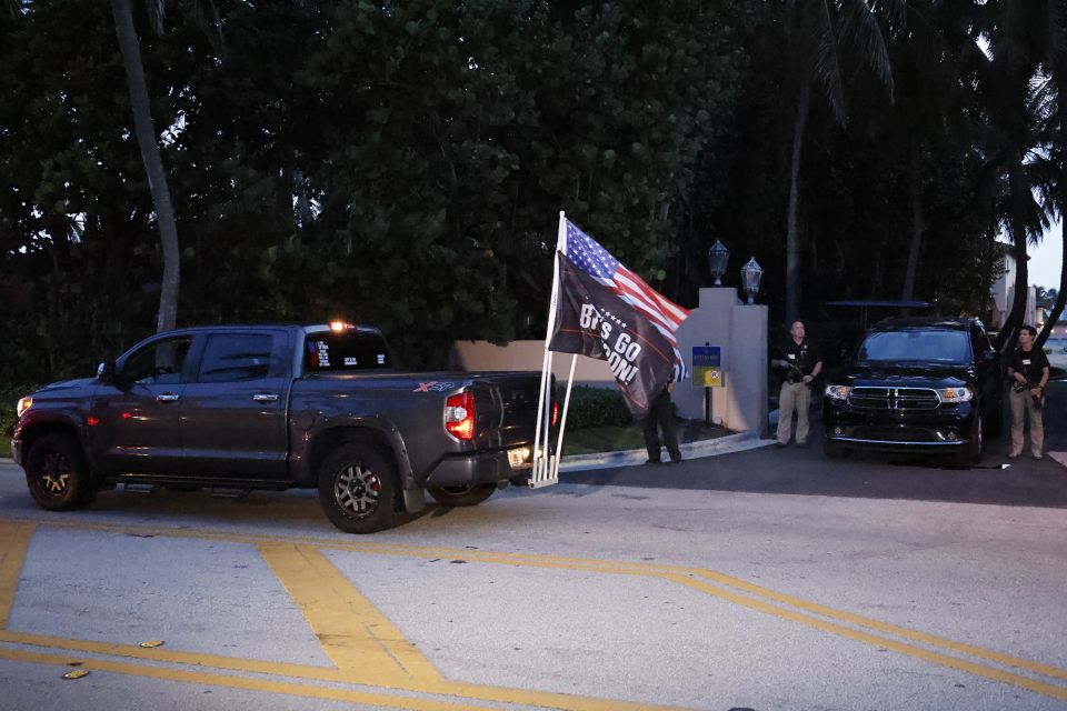 Supporters of former President Donald Trump drive past his Mar-a-Lago estate in Palm Beach, Fla, Aug. 8. The FBI that day conducted a search of his estate, reportedly seeking classified material. (AP/Terry Renna)