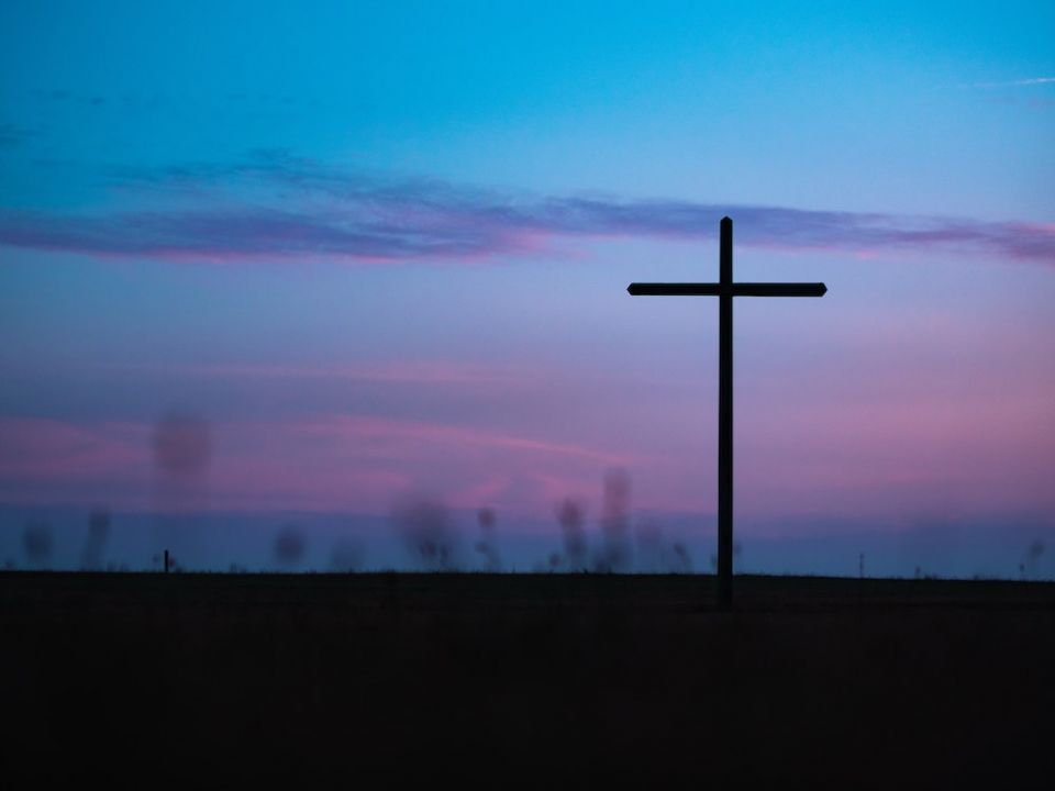 Cross seen in field during sunrise or sunset (Unsplash/Aaron Burden) Cross seen in field during sunrise or sunset (Unsplash/Aaron Burden)