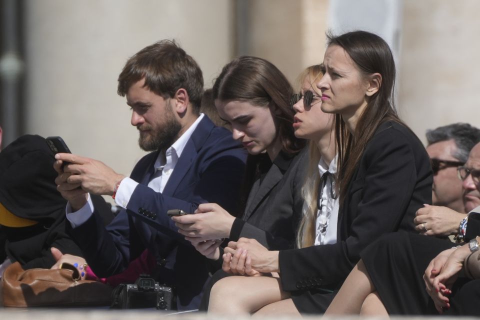 Kateryna Prokopenko, center, wife of Azov Commander Denys Prokopenko, and Yuliia Fedosiuk, second from left, from Ukraine attend Pope Francis weekly general audience in St. Peter's Square at the Vatican, Wednesday, May 11, 2022. (AP Photo/Gregorio Borgia)