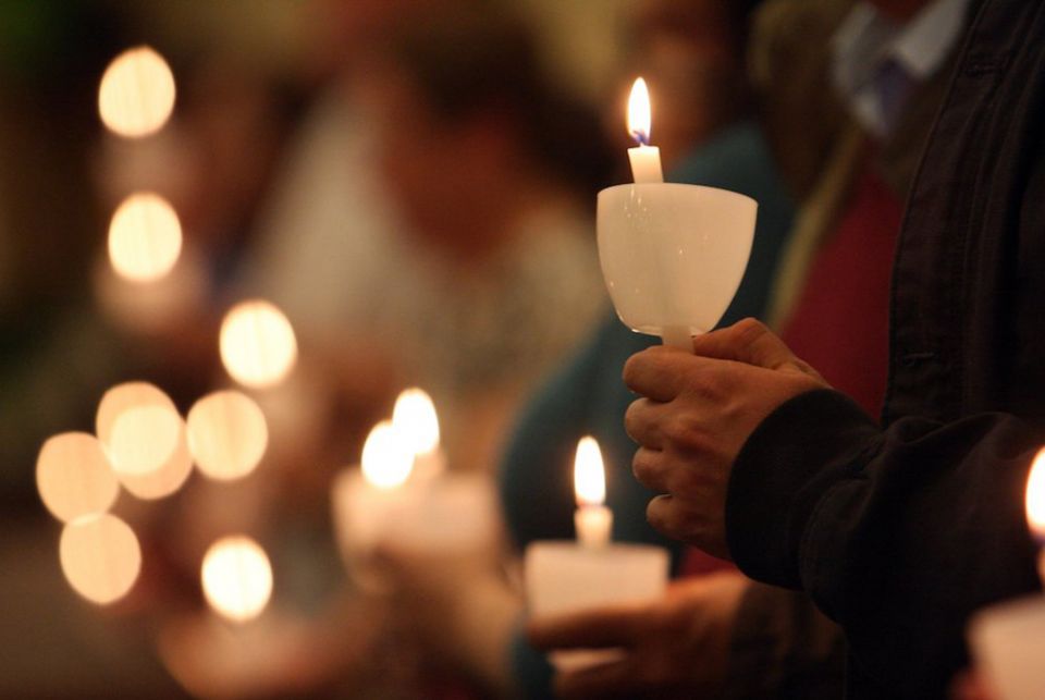 Pictured are worshippers holding candles in this 2012 photo. (CNS file photo/Gregory A. Shemitz)