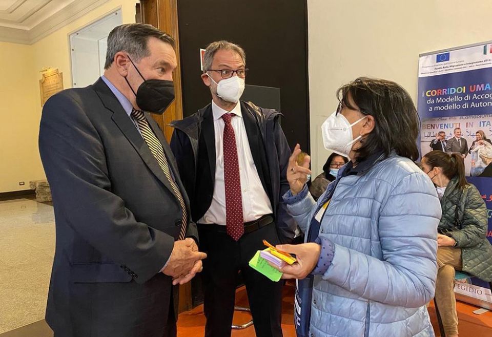 Joe Donnelly, left, U.S. ambassador to the Holy See, talks with a woman during a visit with Ukrainian refugees at the Community of Sant'Egidio's Refugee Welcome Center April 21 in Rome. (Courtesy of U.S. Embassy to the Holy See)