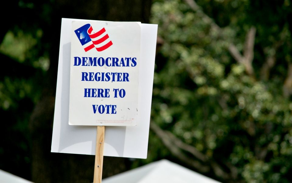 A voter registration sign for the Democratic Party is seen during the March for Science in Sacramento, California, on April 22. (Dreamstime/Alessandra Rc)