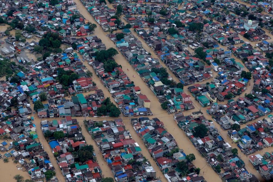 Floodwaters surround homes in Manila, Philippines, following Typhoon Vamco in 2020. Besides being battered by increasingly severe storms, the city is at serious risk from rising sea levels, bishops warn. (CNS photo/Presidential handout photo via Reuters) 