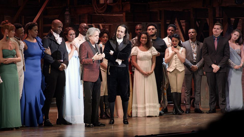 Luis Miranda (center left), on stage with his son, Lin-Manuel Miranda (center right), after Hamilton debuted in Puerto Rico (Courtesy of HBO)